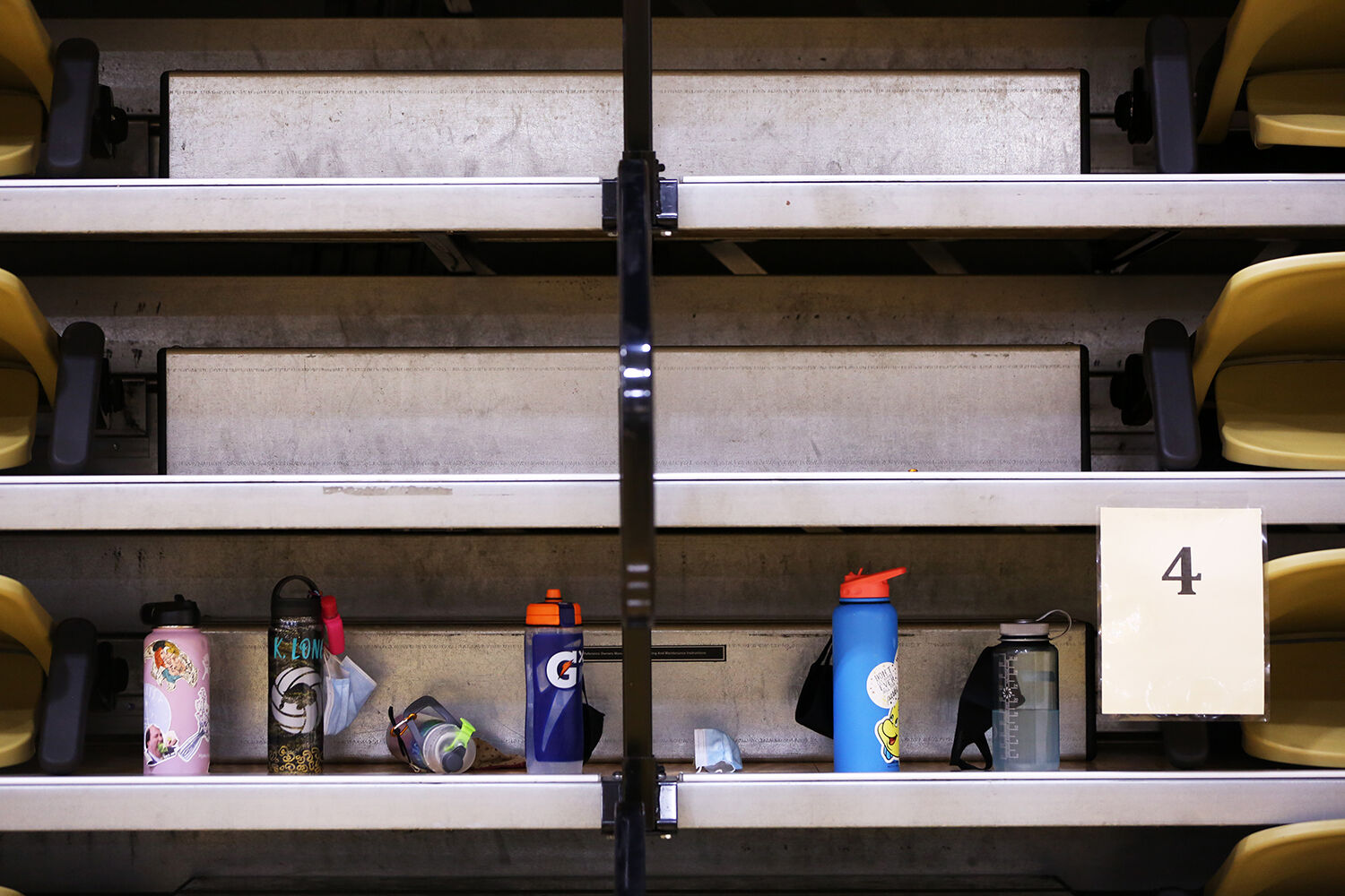 The locked up bleachers served as storage for the girls’ water bottles